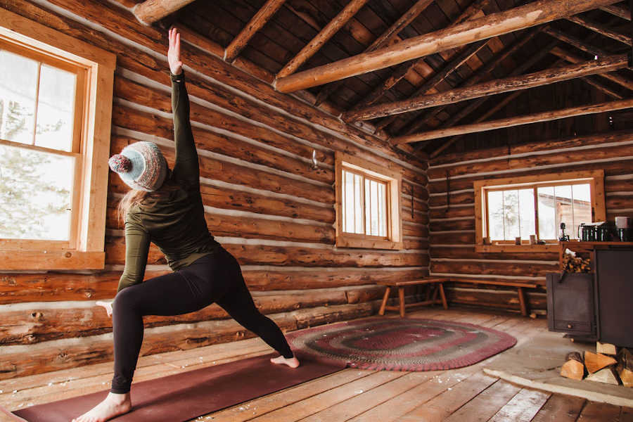 yoga in a rustic cabin at a Colorado resort in winter