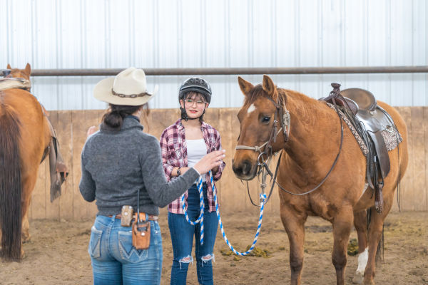 wrangler giving instruction in a horsemanship clinic at winter guest ranch