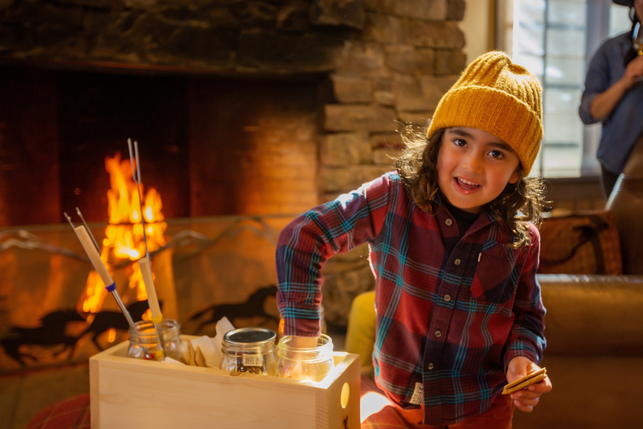 Child eating s'mores by the fire