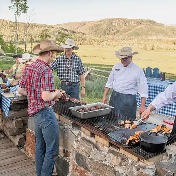 Outdoor cookout on hillside providing stunning western-facing views of the sunset.