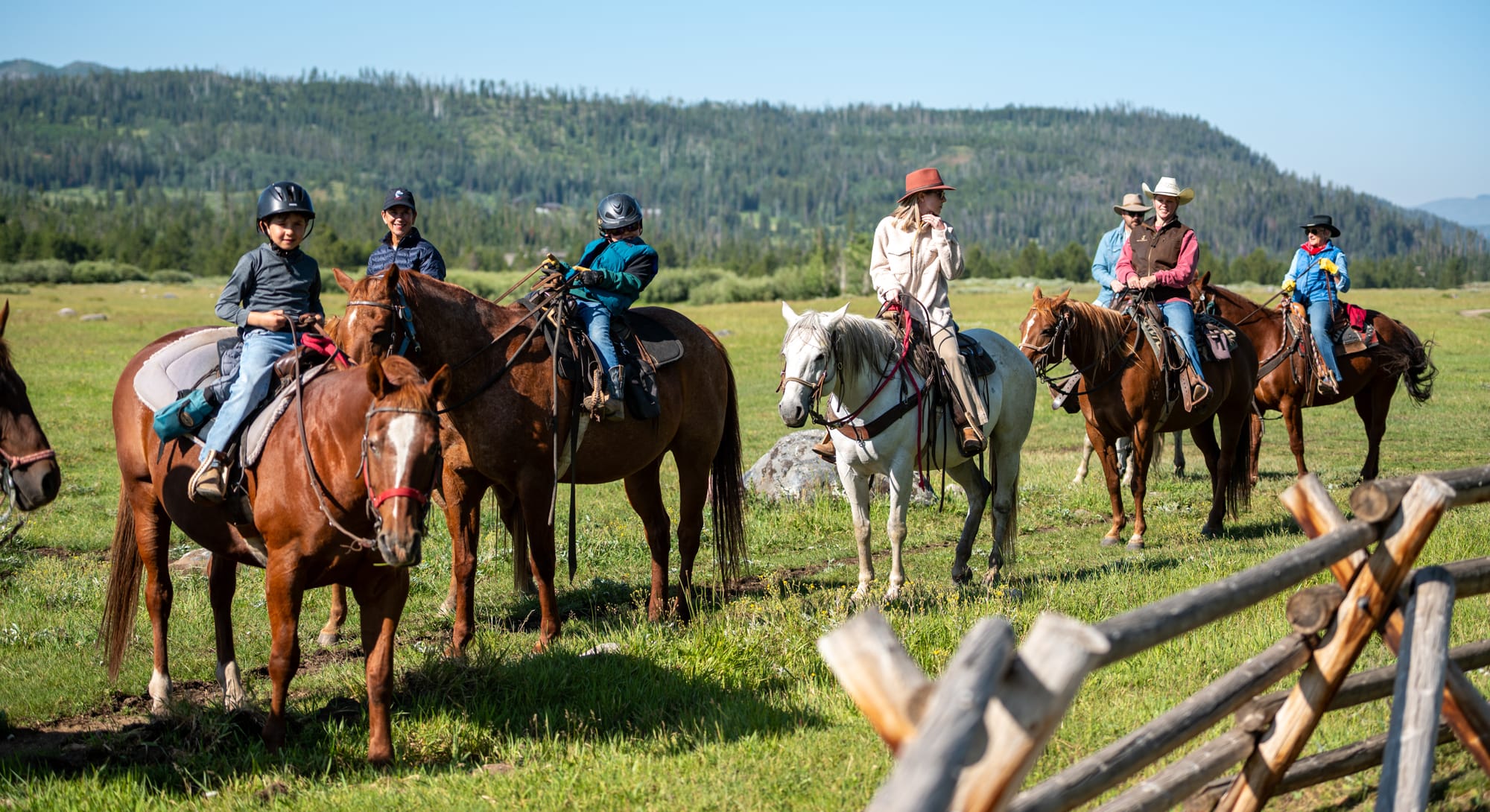 Family Time during Breakfast Ride a group on horseback in a green field