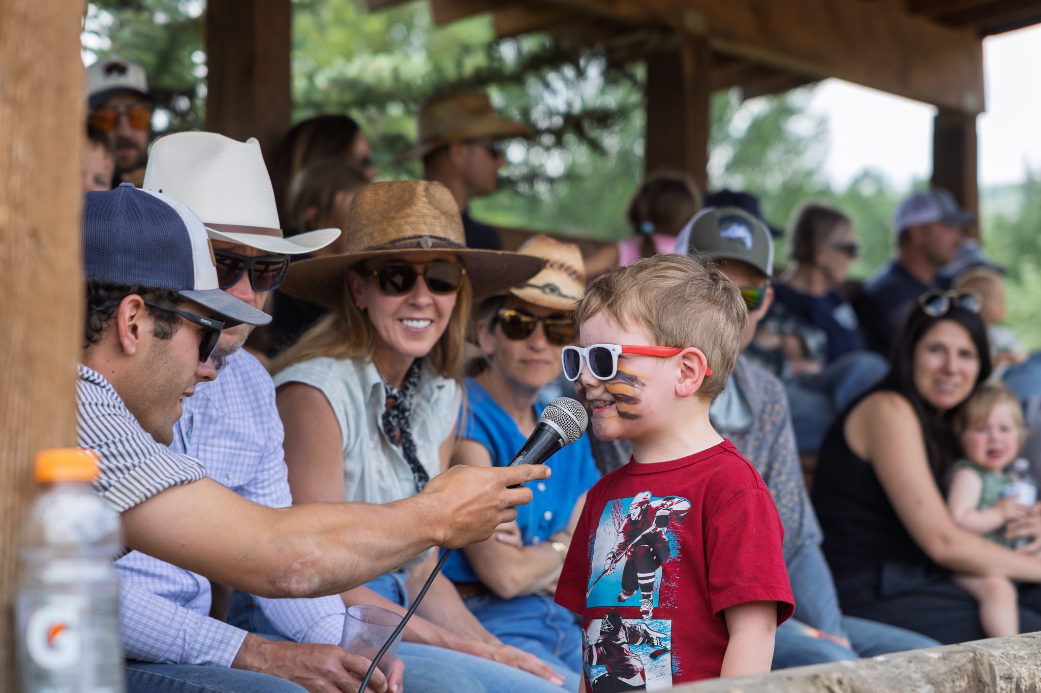 Vista Verde Kids' Rodeo kid talking into a microphone in front of a crowd